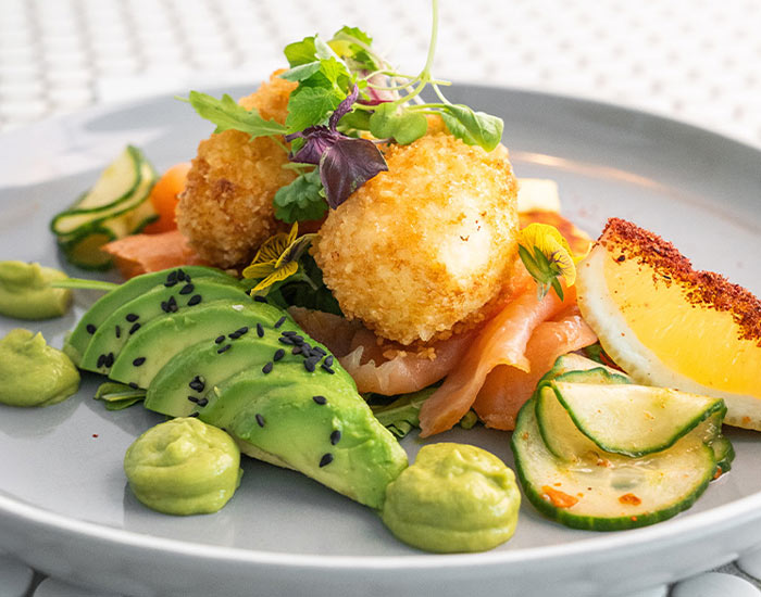 A close up plate of delicious Eggs Norwegian smoked salmon breakfast dish.