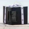A box of four beer glasses with The winey Cow logo in black.