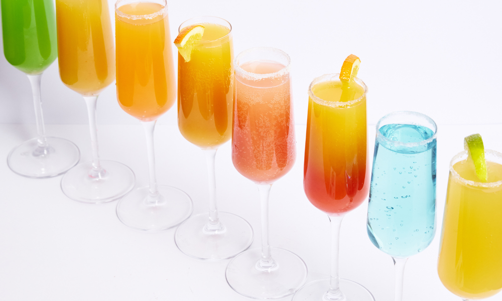 Rainbow of mimosa flavours in champagne flutes, The Winey Cow Boozy Brunch