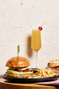 Winey Cow burger and fries with a mimosa, Main Beach brunch café